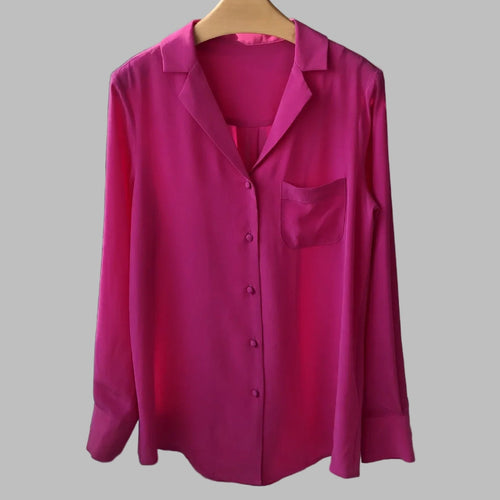 Pink shirt on a hanger against a neutral background